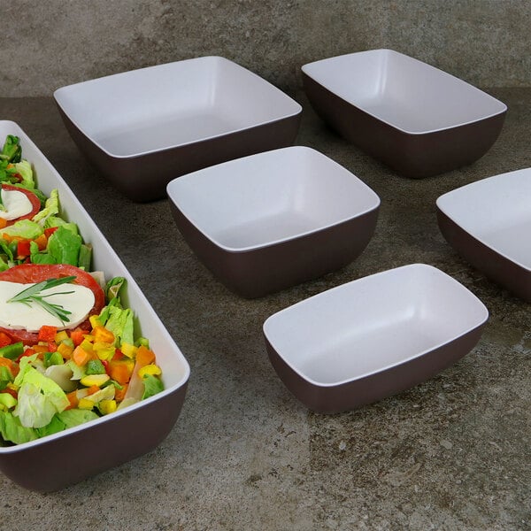 A salad in a white square Elite Global Solutions melamine bowl.