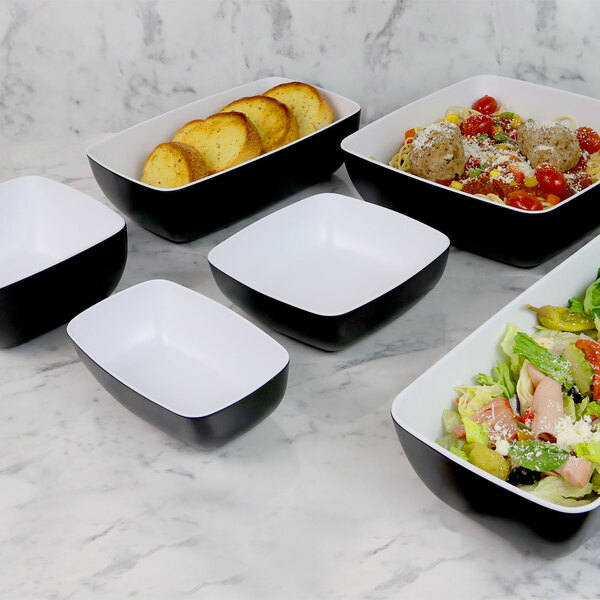 a white square bowl on a black surface