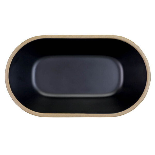 A black oval melamine bowl with a tan rim.
