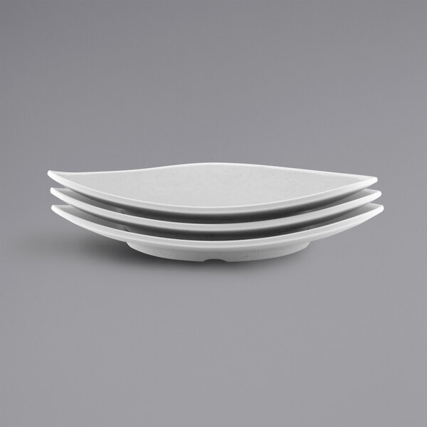 A stack of gray speckled triangle melamine plates.