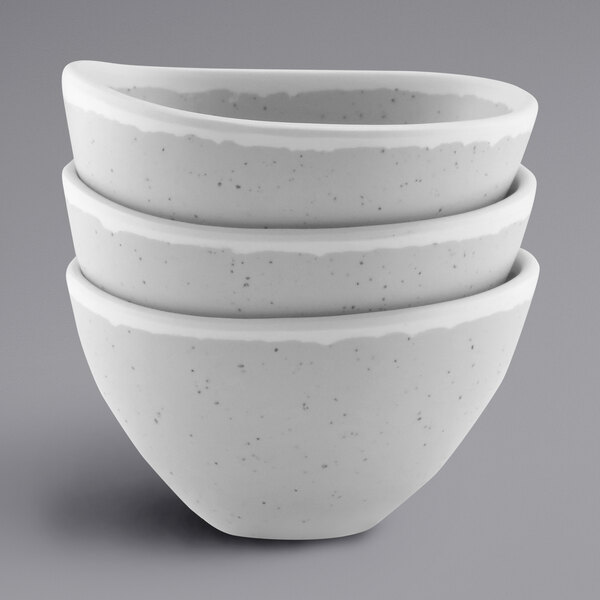 A stack of three gray speckled irregular melamine bowls.