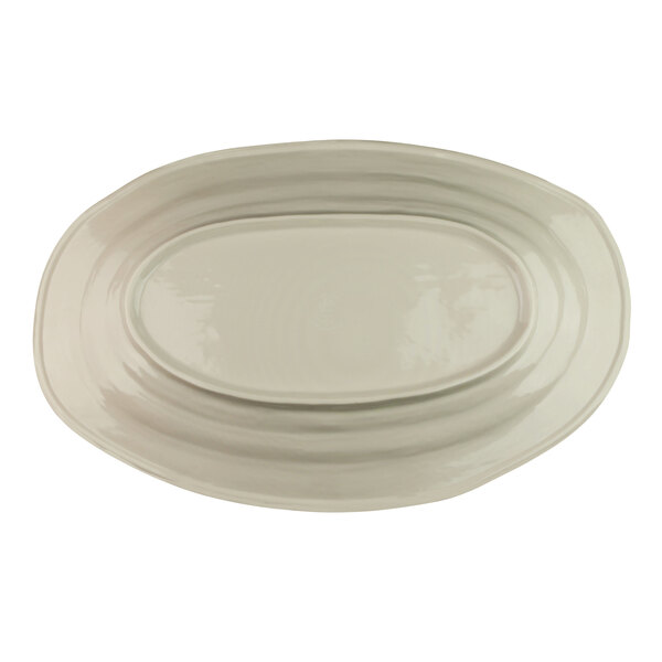 An Elite Global Solutions white melamine tray with an oval shape and oval beach design.