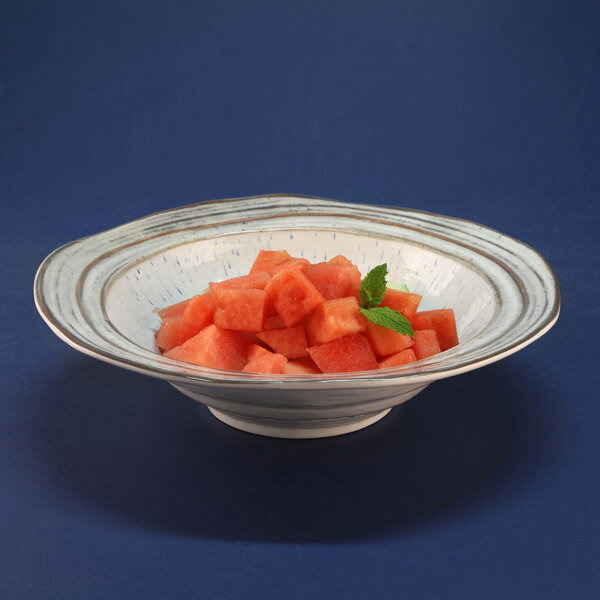 An Elite Global Solutions Doheny melamine bowl with a beach design filled with watermelon cubes.