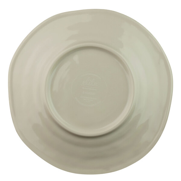 A close-up of a white plate with a round rim.