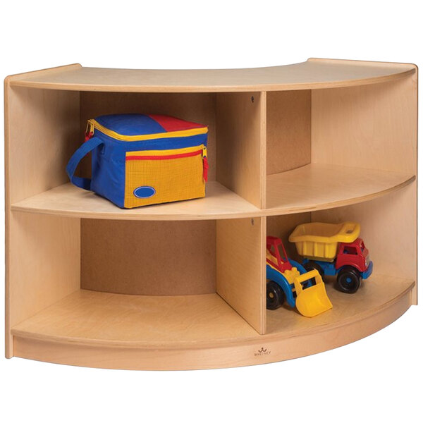 A Whitney Brothers wooden storage cabinet with toys on shelves, including a toy truck with a yellow and blue trailer.