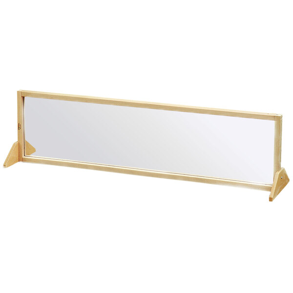A Whitney Brothers rectangular maple wood framed mirror on a stand.