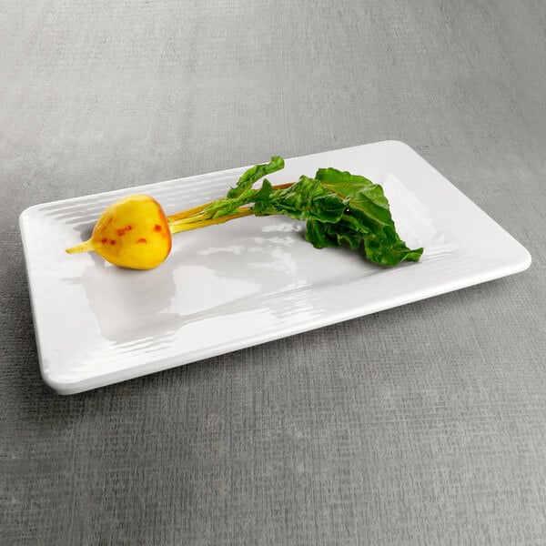 a yellow fruit on a white plate