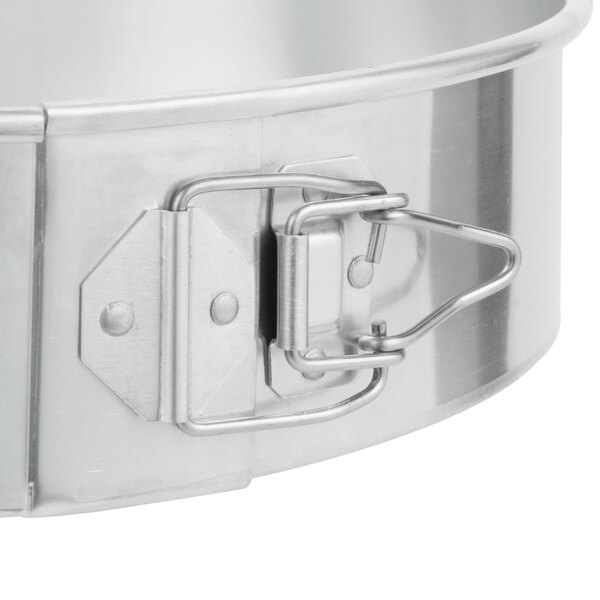 A Chicago Metallic aluminum springform cake pan with a metal handle.