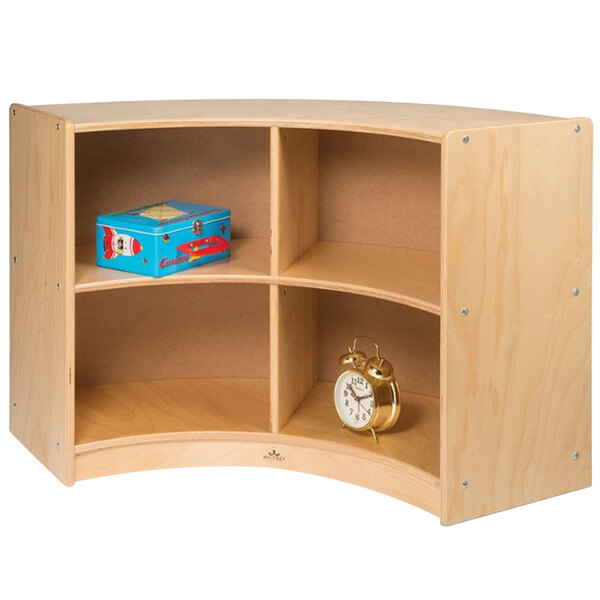 A Whitney Brothers wooden storage cabinet with shelves and a clock on it.