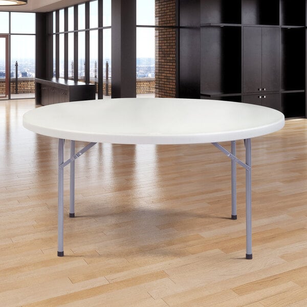A gray NPS round folding table with metal legs.