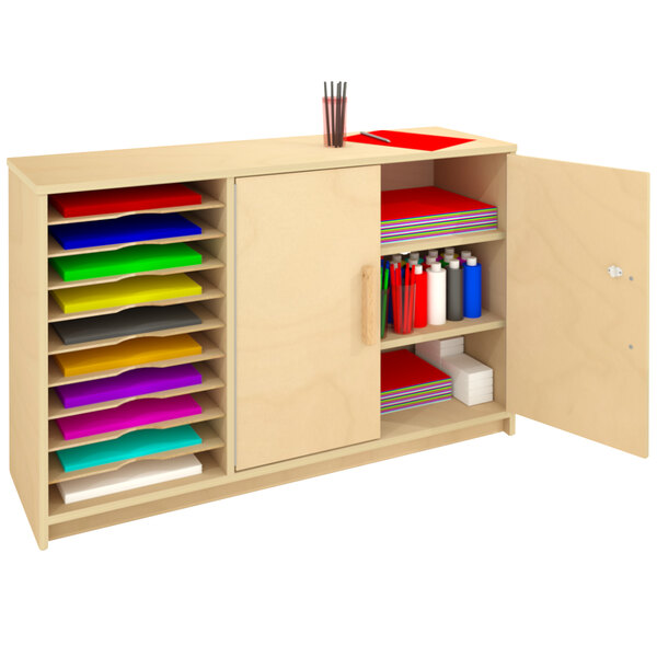 A Whitney Brothers wooden cabinet with an open door revealing a shelf full of paper.