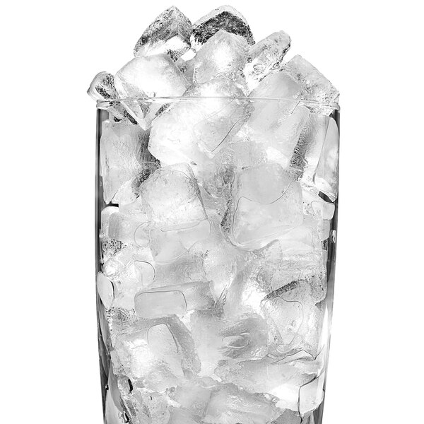 A glass filled with Ice-O-Matic half dice cube ice on a white background.