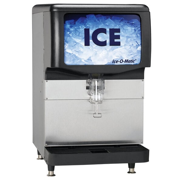 An Ice-O-Matic countertop ice dispenser with a blue and black screen displaying the word "ice"