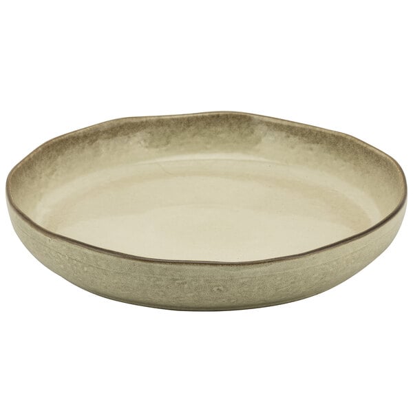 A 10 Strawberry Street beige porcelain deep plate with a brown rim.