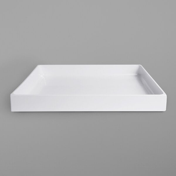 A white rectangular tray on a gray surface.