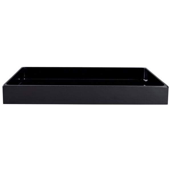 A black rectangular Elite Global Solutions melamine food pan on a table in a salad bar.