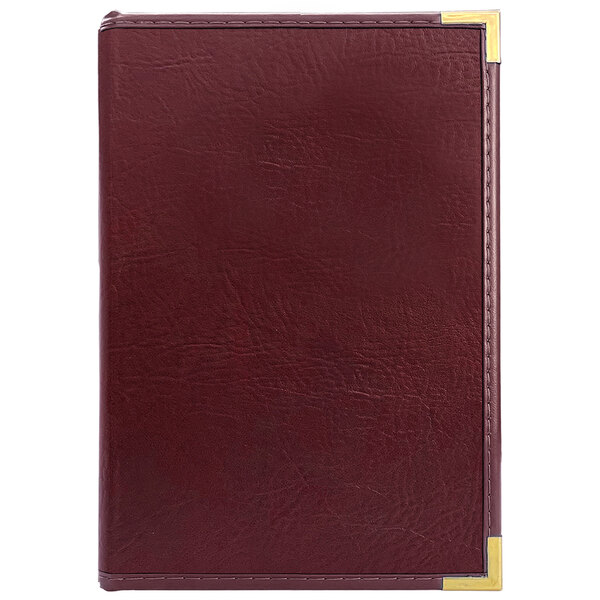 A red leather H. Risch, Inc. Seville menu cover with gold corners.