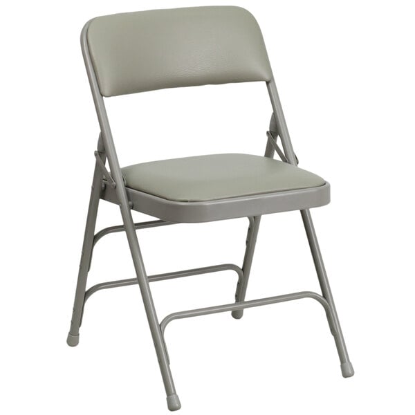 A gray metal folding chair with a padded gray seat.