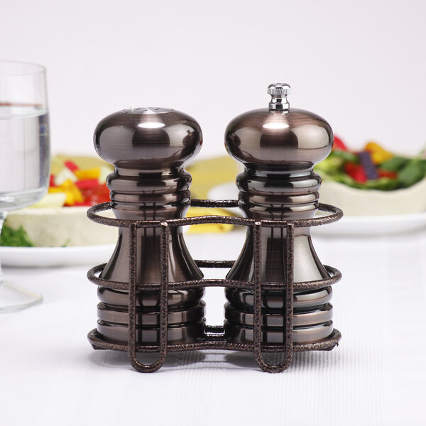 A Chef Specialties burnished copper salt and pepper shaker set on a table.