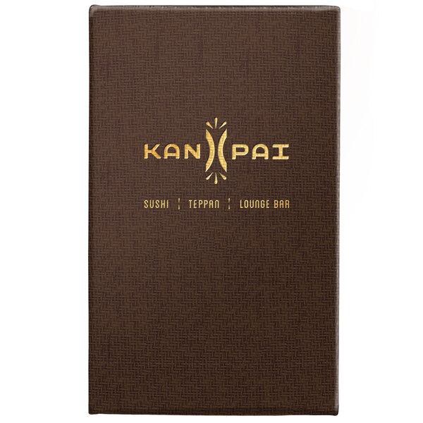A brown rectangular Menu Solutions menu cover with a logo and gold text on a table.