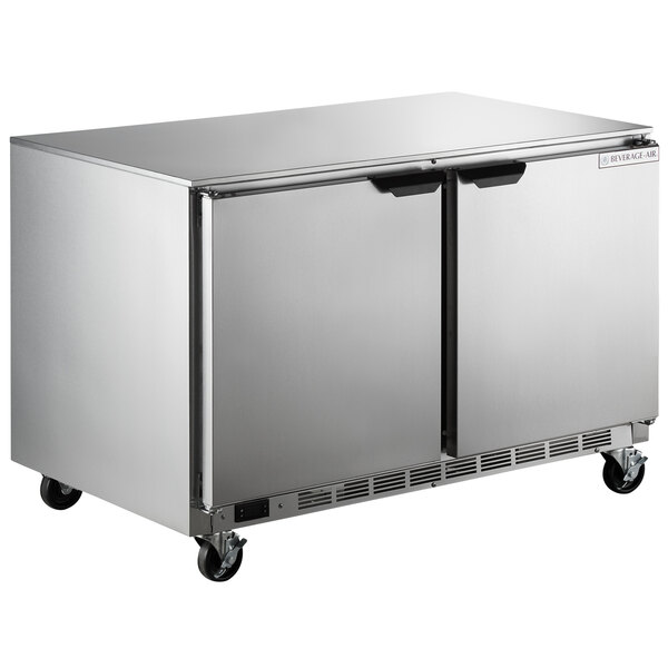 A silver Beverage-Air undercounter freezer with wheels.