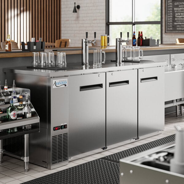 An Avantco stainless steel beer dispenser with two double tap towers on a counter.