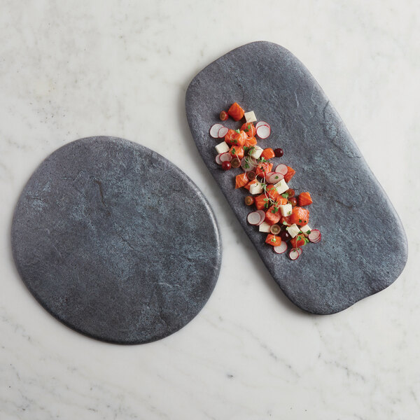 a round black stone on a white surface