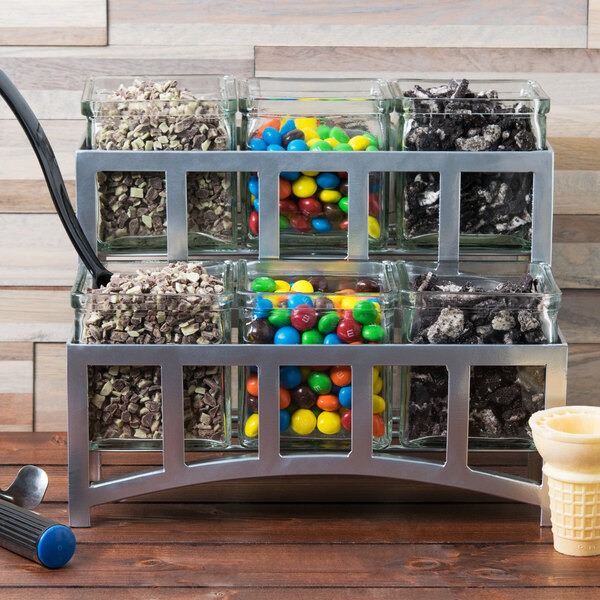 A Cal-Mil Mission silver jar display filled with candy and ice cream.