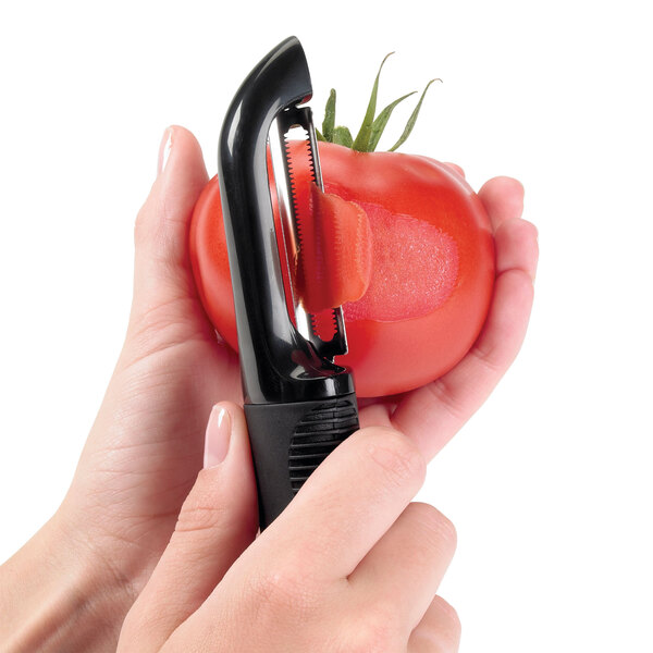 A person using the OXO Straight Vegetable Peeler to peel a tomato.
