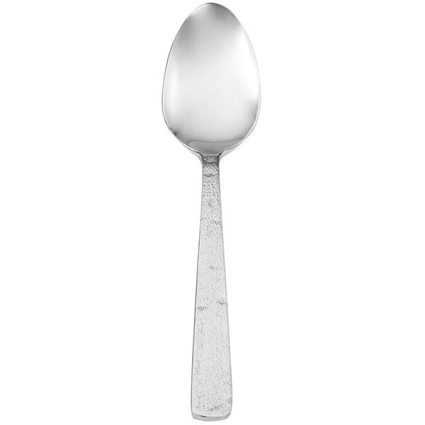 A Walco Vestige stainless steel serving spoon with a white handle.
