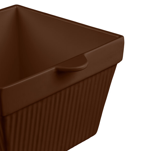 A brown square cast aluminum container with a lid.