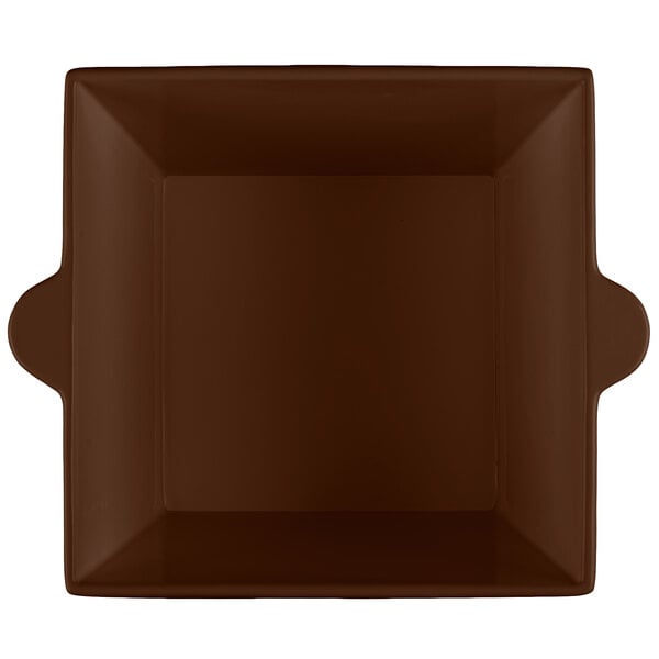 A brown square bowl with handles.