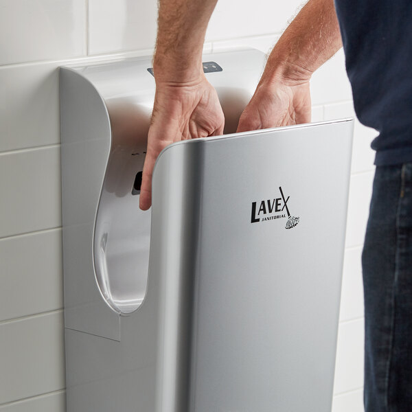 Hands drying inside trough-style electric hand dryer