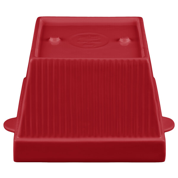 a red plastic object with a white background