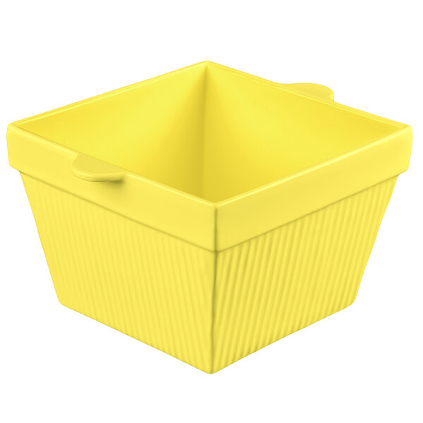 A yellow square cast aluminum container with a lid.