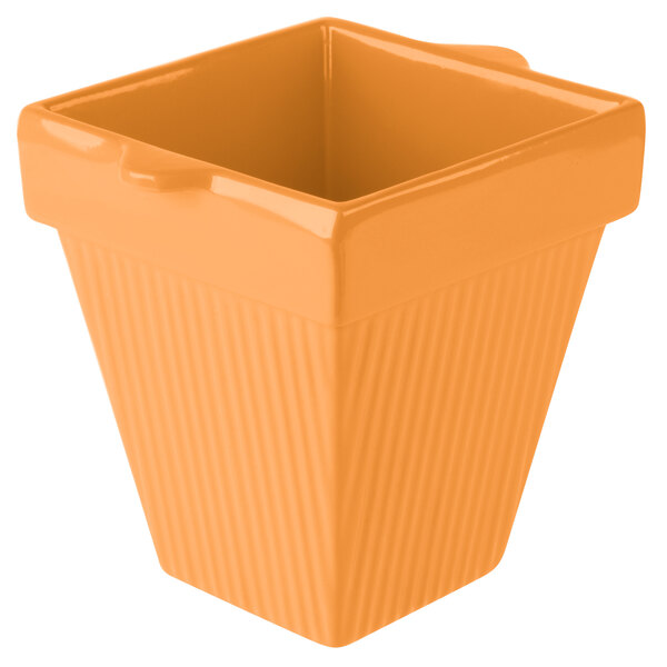 A Tablecraft orange square pot with a lid.