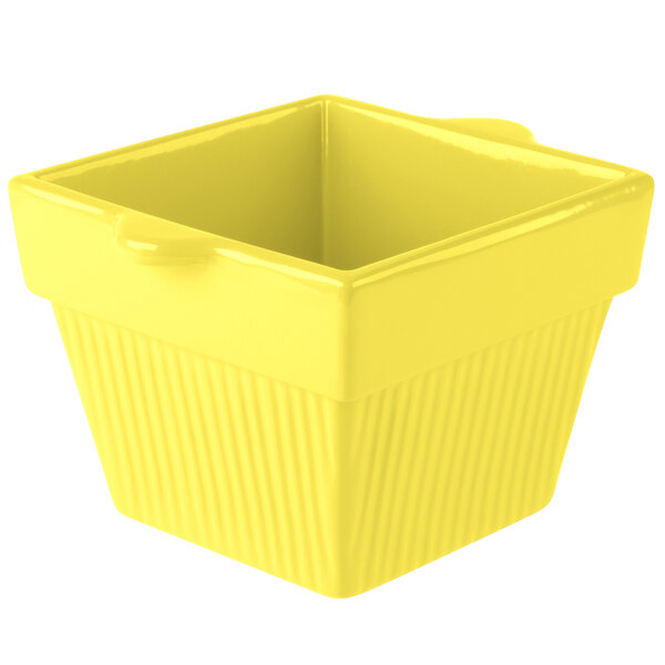 A yellow square cast aluminum container with a lid.