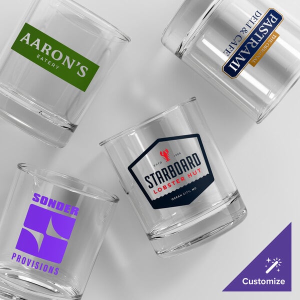 A set of four clear Acopa Straight Up 12 oz. rocks glasses, each with a different custom printed logo.