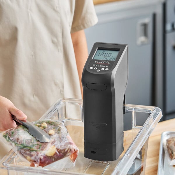 A Breville Commercial CRC-5AC1B Sous Vide Creative Series immersion circulator head being used in a water bath for sous vide cooking.