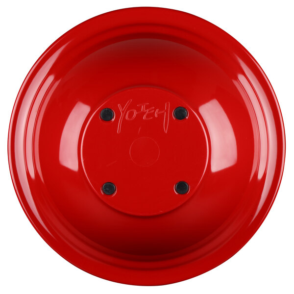 a red bowl with black screws