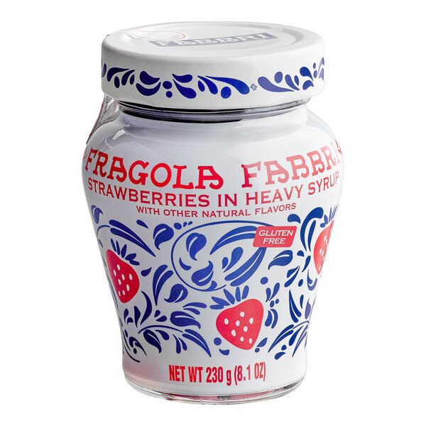 A decorative glass jar with blue floral patterns and red strawberries, labeled 'Fragola Fabbri Strawberries in Heavy Syrup' and 'Gluten Free,' containing 230 grams (8.1 oz) of product.