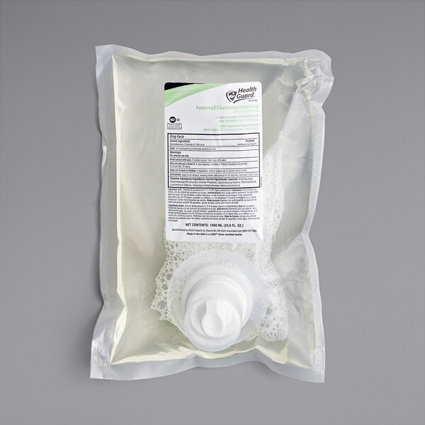 A plastic bag of Kutol Health Guard E2 Sanitizing Hand Soap with a white cap and a bottle inside.