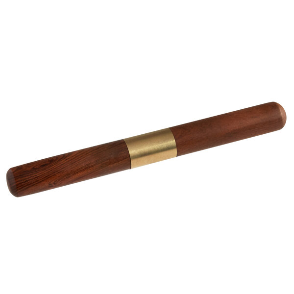 A Barfly ice pick with a wooden handle and brass cover on a table.