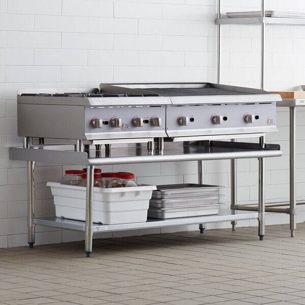 A Steelton stainless steel equipment stand with shelves holding two pans over a stove.