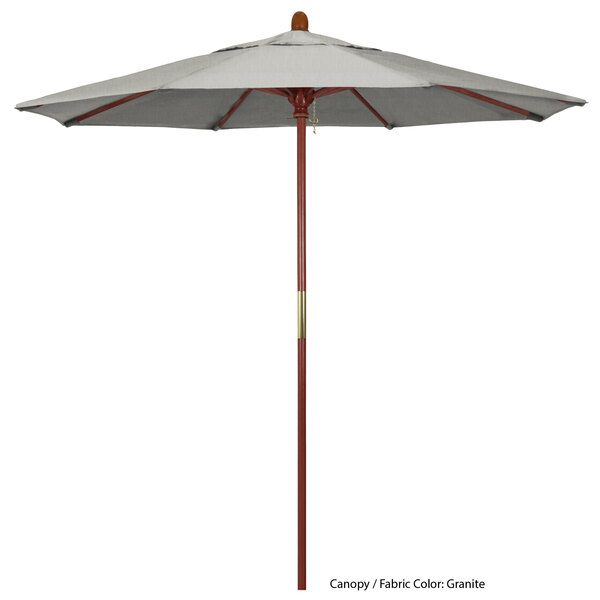 A grey California Umbrella with a Sunbrella canopy on a hardwood pole.