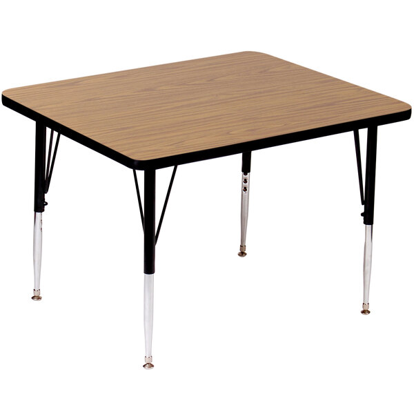 A Correll rectangular activity table with medium oak legs and a wooden top with black edges on it.