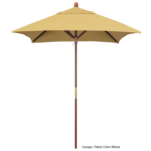 A close-up of a California Umbrella with a tan Sunbrella canopy and hardwood pole.