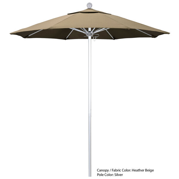 A beige California Umbrella with a white pole on a pole.
