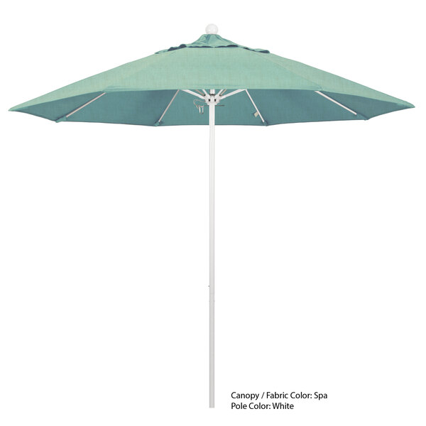 A white California Umbrella with a green Sunbrella canopy.
