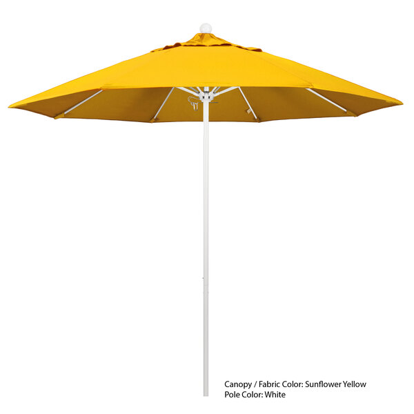 A close-up of a yellow California Umbrella with Sunbrella canopy on a white pole.